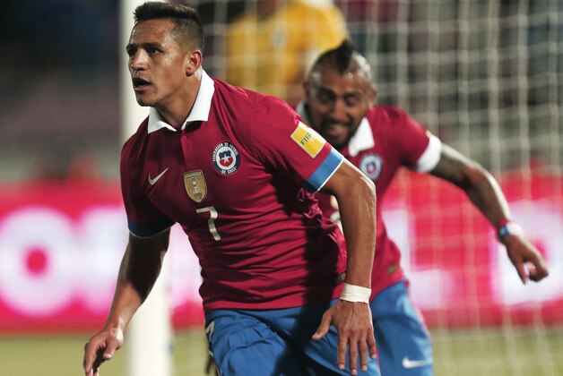 Chile's Alexis Sanchez, left, and Arturo Vidal celebrate after scoring against Brazil during a 2018 World Cup qualifying soccer match in Santiago, Chile, Thursday, Oct. 8, 2015. (AP Photo/ Luis Hidalgo)