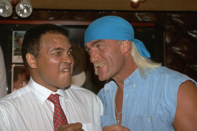 Former heavyweight boxing champ Muhammad Ali, left, is pictured staring down wrestling's Hulk Hogan as the two meet at New York City's Planet Hollywood Wednesday, October 6, 1993.  Hogan was at the restaurant to donate his pink tutu from his new movie, Mr. Nanny  to their movie memorabilia collection when Ali came in for lunch. (AP Photo/Richard Drew)