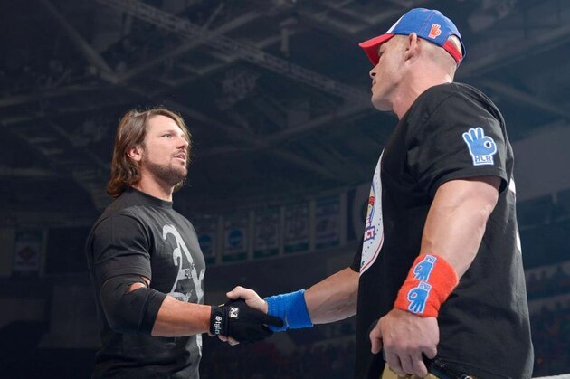 AJ Styles shaking John Cena's hand before stabbing him in the back.