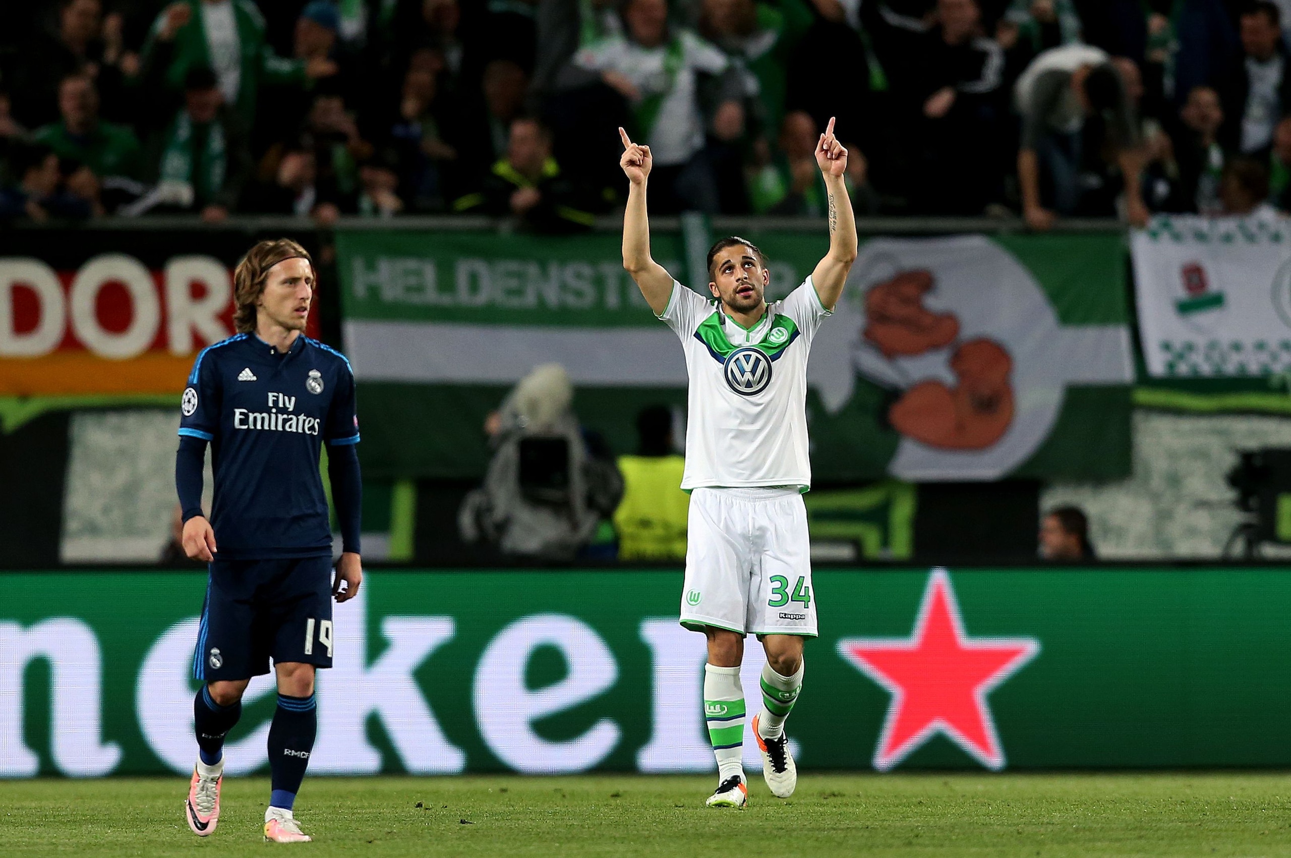 Wolfsburg's Swiss defender Ricardo Rodriguez reacts past Real Madrid's Croatian midfielder Luka Modric (L) vie for the ball during the UEFA Champions League quarter-final, first-leg football match between VfL Wolfsburg and Real Madrid on April 6, 2016 in Wolfsburg, northern Germany.  / AFP / Ronny Hartmann        (Photo credit should read RONNY HARTMANN/AFP/Getty Images)