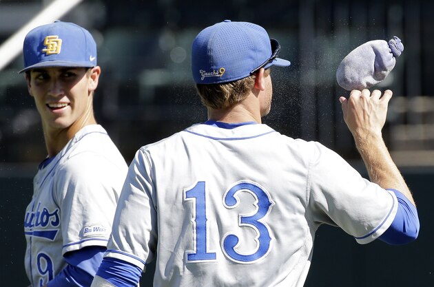 UC Santa Barbara third baseman Ryan Clark (13) bounces a rosin bag on his hand as he talks with second baseman J. J. Muno, left, in the sixth inning of an NCAA college baseball regional tournament game against Xavier, Monday, June 6, 2016, in Nashville, Tenn. (AP Photo/Mark Humphrey)