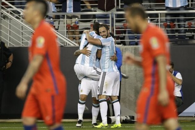 Argentina’s Gonzalo Higuain, right, and Argentina’s Angel Di Maria, left, hug Argentina’s Ever Banega, background, after Banega scored against Chile during a Copa America Centenario Group A soccer match at the Levi's Stadium in Santa Clara, Calif., Monday, June 6, 2016. (AP Photo/ Marcio Jose Sanchez)