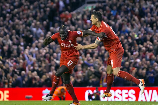Liverpool's Mamadou Sakho, left, celebrates with teammate Dejan Lovren after scoring past Everton's goalkeeper Joel Robles during the English Premier League soccer match between Liverpool and Everton at Anfield Stadium, Liverpool, England, Wednesday, April 20, 2016. (AP Photo/Jon Super)