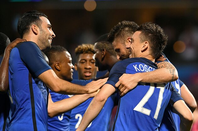 France's defender Laurent Koscielny (C) is congratuled by France's defender Adil Rami (L) and France's forward Olivier Giroud during the friendly football match between France and Scotland, at the St Symphorien Stadium in Longeville-lès-Metz, Eastern France, on June 4, 2016.  / AFP / FRANCK FIFE        (Photo credit should read FRANCK FIFE/AFP/Getty Images)