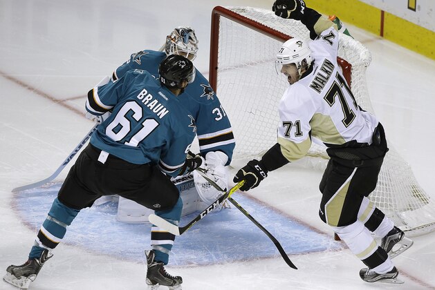 Pittsburgh Penguins' Evgeni Malkin, right, celebrates after scoring a goal against San Jose Sharks goalie Martin Jones and Justin Braun (61) during the second period of Game 4 of the NHL hockey Stanley Cup Finals, Monday, June 6, 2016, in San Jose, Calif. (AP Photo/Eric Risberg)