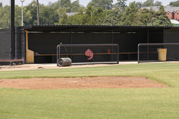 This photo shows an empty dugout on the baseball field at East Central University in Ada, Okla., Wednesday, Aug. 21, 2013.  Australian Christopher Lane, who was on a baseball scholarship at East Central University was in Duncan, Okla., visiting his girlfriend, when he was shot and killed. (AP Photo/Sue Ogrocki)