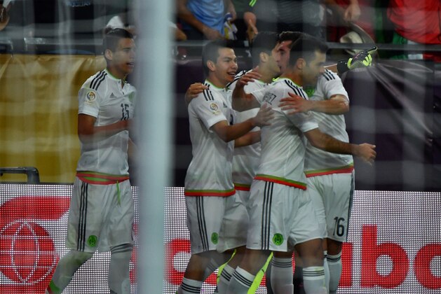 Mexico's Rafael Marquez (R) celebrates with teammates after scoring against Uruguay during their Copa America Centenario football tournament match in Glendale, Arizona, United States, on June 5, 2016.  / AFP / Nelson ALMEIDA        (Photo credit should read NELSON ALMEIDA/AFP/Getty Images)