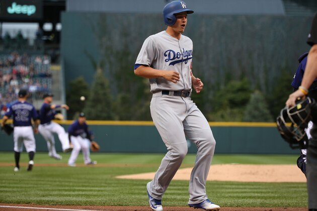 DENVER, CO - APRIL 23:  Corey Seager #5 of the Los Angeles Dodgers scores as short stop Trevor Story #27 of the Colorado Rockies throws out Adrian Gonzalez #23 of the Los Angeles Dodgers on a ground ball in the first inning at Coors Field on April 23, 2016 in Denver, Colorado. The Dodgers defeated the Rockies 4-1. (Photo by Doug Pensinger/Getty Images)