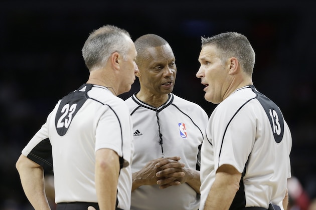 From left, referees Jason Phillips (23), Michael Smith, center, and Monty McCutchen (13) talk during the second half in Game 3 of a first-round NBA basketball playoff series between the Detroit Pistons and the Cleveland Cavaliers, Friday, April 22, 2016 in Auburn Hills, Mich. (AP Photo/Carlos Osorio)