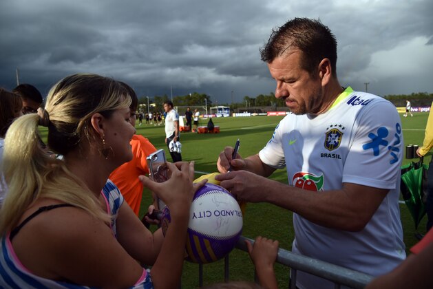 Coach of Brazil Carlos Caetano Bledorn Verri (R), known as Dunga, signs autographs for fans after a training session at the University of Central Florida (UCF) in Orlando, Florida, on June 7, 2016, one day before their Copa America 2016 match against Haiti. / AFP / HECTOR RETAMAL        (Photo credit should read HECTOR RETAMAL/AFP/Getty Images)