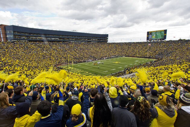 Fans in the student section of Michigan Stadium wave pom-poms in the first quarter of an NCAA college football game against Michigan State in Ann Arbor, Mich., Saturday, Oct. 17, 2015. (AP Photo/Tony Ding)