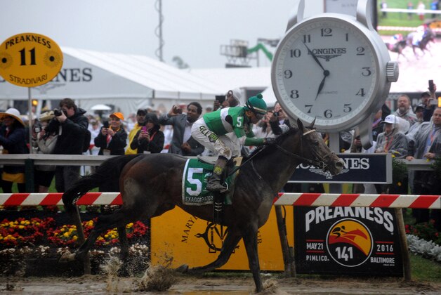 IMAGE DISTRIBUTED FOR LONGINES - Exaggerator, ridden by jockey Kent J. Desormeaux, wins the second leg of the Triple Crown at the 141st Preakness Stakes, Saturday, May 21, 2016, at a muddy Pimlico Race Course in Baltimore. Longines, the Swiss watch manufacturer known for its elegant timepieces, is the Official Watch and Timekeeper of the 141st annual Preakness Stakes and the Triple Crown. (Diane Bondareff/AP Images for Longines)