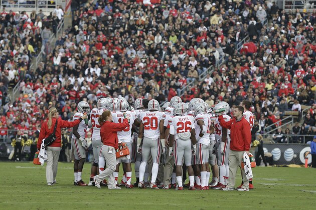 The Ohio State team huddles during the first half of an NCAA college football game against Purdue in West Lafayette, Ind., Saturday, Nov. 2, 2013. (AP Photo/Michael Conroy)