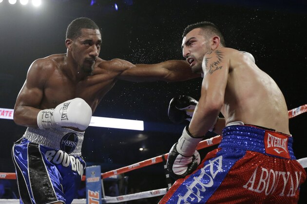 Demetrius Andrade, left, hits Vanes Martirosyan, right, during their WBO junior middle title bout, Saturday,  Nov. 9, 2013, in Corpus Christi, Texas. (AP Photo/Eric Gay)