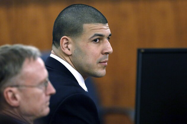 FILE - In this Thursday, April 9, 2015, file photo, former New England Patriots football player Aaron Hernandez, right, sits with defense attorney Charles Rankin, left, before the jury began deliberations in his murder trial in Fall River, Mass. Hernandez was convicted of murder and sentenced to life imprisonment for the 2013 shooting death of Odin Lloyd. The story was a top news item in Massachusetts in 2015. (AP Photo/Steven Senne, Pool, File)