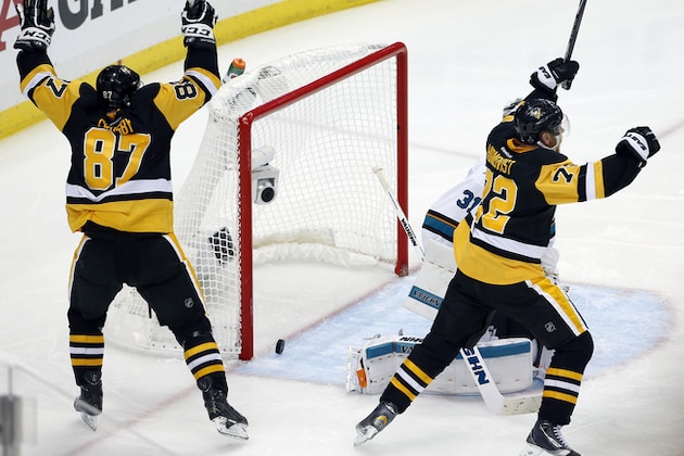 Pittsburgh Penguins' Sidney Crosby (87) and Patric Hornqvist, right, celebrate a goal by Conor Sheary against San Jose Sharks goalie Martin Jones (31) during overtime in Game 2 of the NHL hockey Stanley Cup Finals on Wednesday, June 1, 2016, in Pittsburgh. The Penguins won 2-1 to take a 2-0 lead in the series. (AP Photo/Gene J. Puskar)