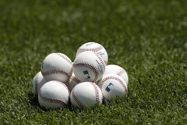Baseballs are stacked on the field during warmups before a baseball game between the Kansas City Royals and the New York Yankees Sunday, May 12, 2013, in Kansas City, Mo. (AP Photo/Charlie Riedel)