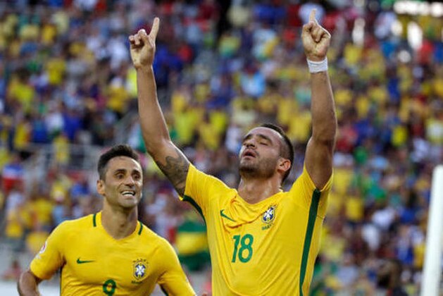Brazil's Renato Augusto (18) celebrates after scoring a goal against Haiti as teammate Jonas (9) comes in to join the celebration during the first half of a Copa America group B soccer match Wednesday, June 8, 2016, in Orlando, Fla. (AP Photo/John Raoux)