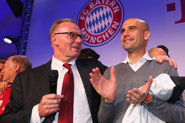 In this May 21, 2016  picture  Karl-Heinz Rummenigge, CEO of Bayern Munich, left, and outgoing soccer coach Pep  Guardiola,  celebrate during a  party after winning the German Soccer Cup in a final versus Borussia Dortmund  in Berlin, Germany. (Alexander Hassenstein/Pool Photo via AP)