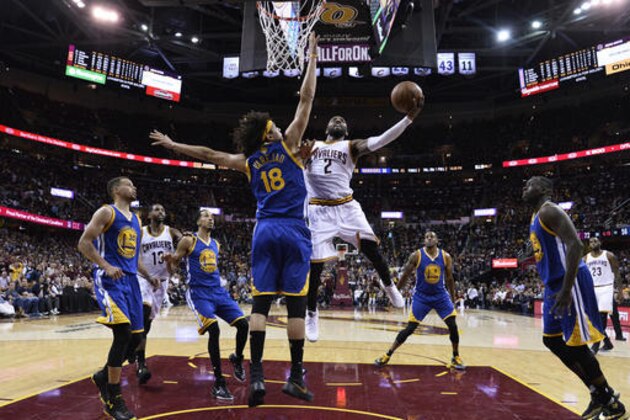 Cleveland Cavaliers guard Kyrie Irving (2) drives against Golden State Warriors forward Anderson Varejao (18) during the second half of Game 3 of basketball's NBA Finals in Cleveland, Thursday, June 9, 2016. Cleveland won 120-90. (Larry W. Smith/EPA via AP, Pool)