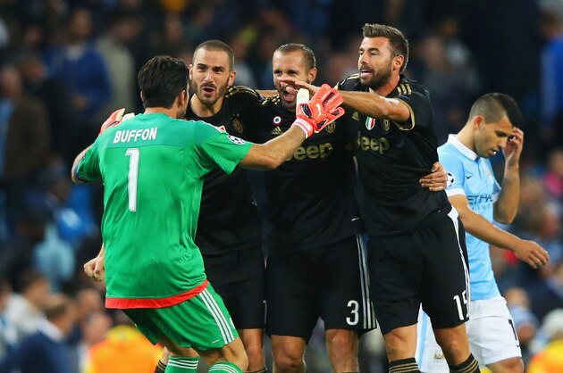 MANCHESTER, ENGLAND - SEPTEMBER 15:  Gianluigi Buffon, Leonardo Bonucci, Giorgio Chiellini and Andrea Barzagli of Juventus celebrate victory as Sergio Aguero of Manchester City look dejected after the UEFA Champions League Group D match between Manchester City FC and Juventus at the Etihad Stadium on September 15, 2015 in Manchester, United Kingdom.  (Photo by Alex Livesey/Getty Images)