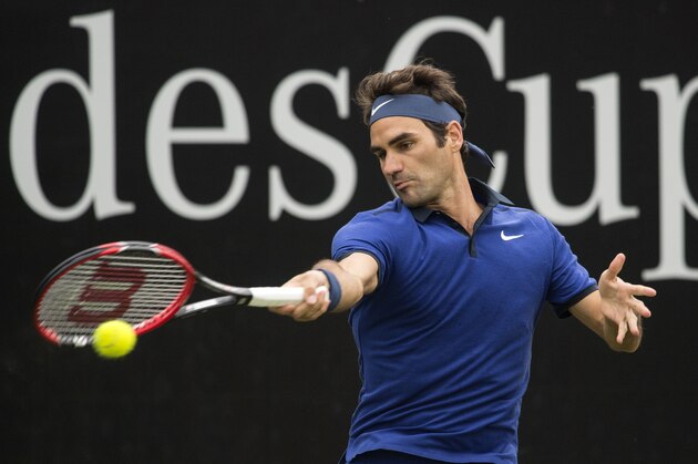 Switzerland's Roger Federer returns the ball to US Taylor Fritz in their round of sixteen match at the ATP Cup tennis tournament in Stuttgart, southwestern Germany, on June 8, 2016.   / AFP / THOMAS KIENZLE        (Photo credit should read THOMAS KIENZLE/AFP/Getty Images)