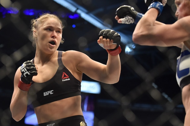 Ronda Rousey of the US (L) lines up compatriot Holly Holm during the UFC title fight in Melbourne on November 15, 2015.   RESTRICTED TO EDITORIAL USE NO ADVERTISING USE NO PROMOTIONAL USE NO MERCHANDISING USE.  AFP PHOTO/Paul CROCK        (Photo credit should read PAUL CROCK/AFP/Getty Images)