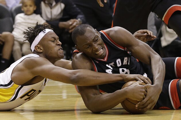 Indiana Pacers' Myles Turner (33) and Toronto Raptors' Bismack Biyombo (8) battle for a loose ball during the second half of Game 4 of an NBA first-round playoff basketball series Saturday, April 23, 2016, in Indianapolis. Indiana won 100-83. (AP Photo/Darron Cummings)