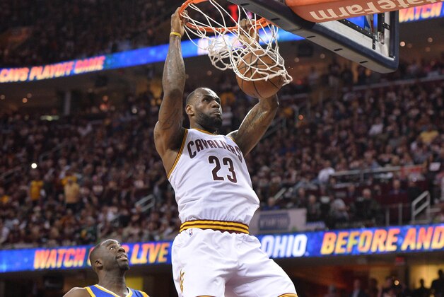 Jun 8, 2016; Cleveland, OH, USA; Cleveland Cavaliers forward LeBron James (23) dunks the ball in front of Golden State Warriors forward Draymond Green (23) during the four quarter in game three of the NBA Finals at Quicken Loans Arena. Mandatory Credit: Ken Blaze-USA TODAY Sports