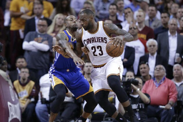 Cleveland Cavaliers forward LeBron James (23) drives on Golden State Warriors forward Andre Iguodala during the first half of Game 3 of basketball's NBA Finals in Cleveland, Wednesday, June 8, 2016. (AP Photo/Tony Dejak)