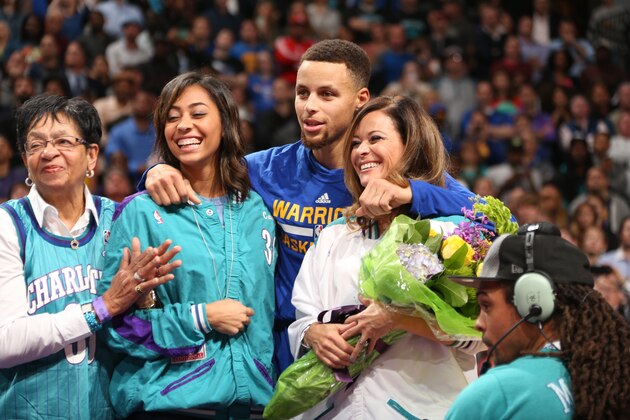 CHARLOTTE, NC - DECEMBER 2:  Stephen Curry #30 of the Golden State Warriors, Sydel Curry and Sonya Curry look on during a halftime ceremony to honor former Charlotte Hornets player Dell Curry on December 2, 2015 at Time Warner Cable Arena in Charlotte, North Carolina. NOTE TO USER: User expressly acknowledges and agrees that, by downloading and or using this photograph, User is consenting to the terms and conditions of the Getty Images License Agreement.  Mandatory Copyright Notice:  Copyright 2015 NBAE (Photo by Kent Smith/NBAE via Getty Images)