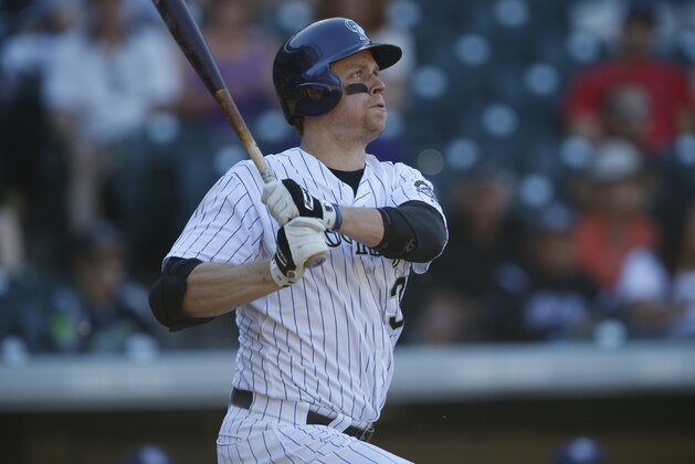 Colorado Rockies first baseman Justin Morneau (33) doubles against the San Diego Padres in the seventh inning of a baseball game Sunday, Sept. 20, 2015, in Denver. San Diego won 10-4. (AP Photo/David Zalubowski)