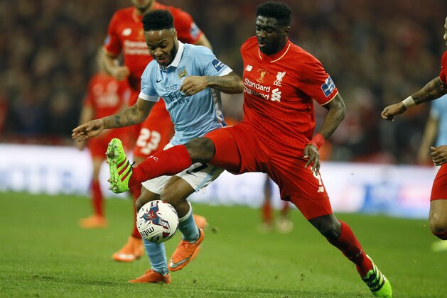 Manchester City's Raheem Sterling, left, and Liverpool’s Kolo Toure challenge for the ball during the English League Cup final soccer match between Liverpool and Manchester City at Wembley stadium in London, Sunday, Feb. 28, 2016.(AP Photo/Kirsty Wigglesworth)