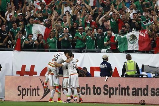 Mexico's Hector Herrera (16) and Hector Moreno (15) celebrate with teammates on a goal against Uruguay during the second half of a Copa America group C soccer match at University of Phoenix Stadium Sunday, June 5, 2016, in Glendale, Ariz. Mexico defeated Uruguay 3-1. (AP Photo/Ross D. Franklin)
