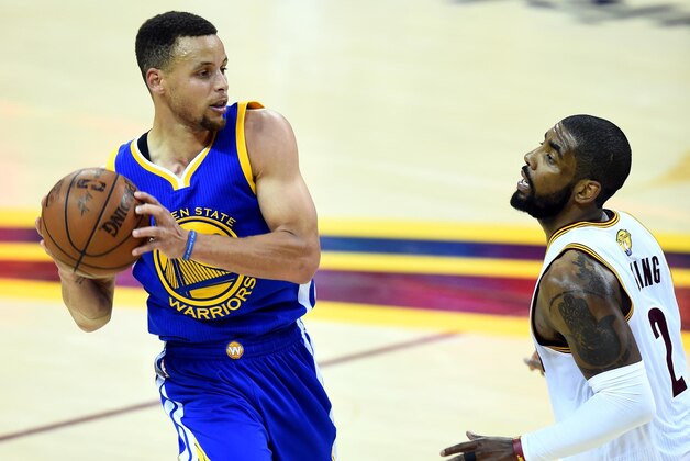 Jun 8, 2016; Cleveland, OH, USA; Golden State Warriors guard Stephen Curry (30) handles the ball against Cleveland Cavaliers guard Kyrie Irving (2) during the third quarter in game three of the NBA Finals at Quicken Loans Arena. Mandatory Credit: Bob Donnan-USA TODAY Sports