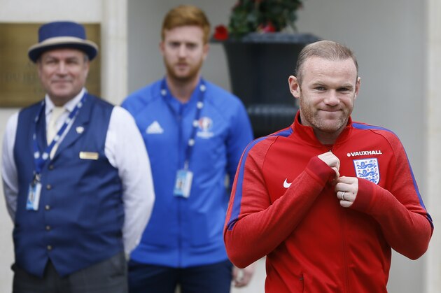 England’s Wayne Rooney, right, smiles as he leaves the team hotel in Chantilly, France, Thursday, June 9, 2016. England will face Russia in a Euro 2016 Group B soccer match in Marseille on Saturday, June 11. (AP Photo/Kirsty Wigglesworth)