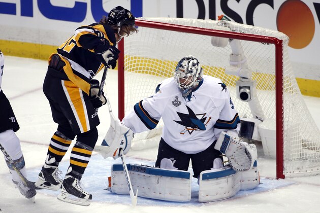 Pittsburgh Penguins' Carl Hagelin, left, scores a goal against San Jose Sharks goalie Martin Jones (31) during the first period in Game 5 of the NHL hockey Stanley Cup Finals on Thursday, June 9, 2016, in Pittsburgh. (AP Photo/Gene J. Puskar)