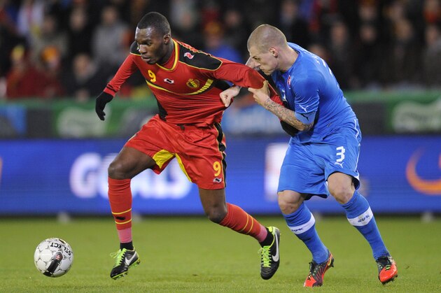 Belgium's Christian Benteke (L) and Slovakia's Martin Skrtel (R) vie for the ball during their friendly football match in Bruges on February 6, 2013. AFP PHOTO / JOHN THYS        (Photo credit should read JOHN THYS/AFP/Getty Images)