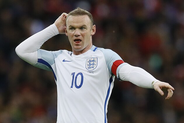 England's captain Wayne Rooney directs the players during the international friendly soccer match between England and Portugal at Wembley stadium in London, Thursday, June 2, 2016. (AP Photo/Kirsty Wigglesworth)
