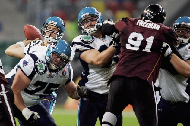 D?SSELDORF, GERMANY - MAY 07:  Quarterback Casey Bramlet of Hamburg pulls back to throw the ball under pressure from the Rhein defensive line during the NFL Europe match between Rhein Fire and Hamburg Sea  Devils at the LTU Arena on May 7, 2005 in Dusseldorf, Germany. (Photo by Lars Baron/Getty Images)