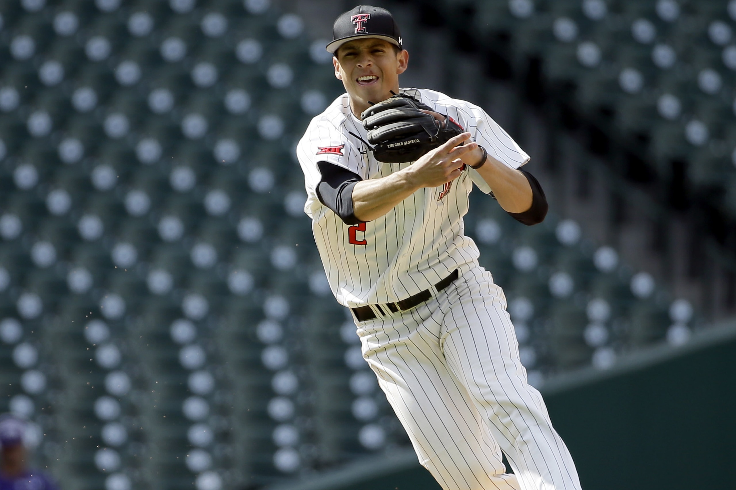 Texas Tech shortstop Orlando Garcia throws to first for the out after fielding a ball hit by Arkansas's Carson Shaddy during the sixth inning of a College Classic baseball game Sunday, Feb. 28, 2016, in Houston. (AP Photo/David J. Phillip)