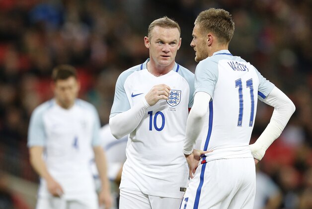 England's Wayne Rooney, center, talks to England's Jamie Vardy during the International friendly soccer match between England and Portugal at Wembley stadium in London, England, Thursday, June 2, 2016 . (AP Photo/Frank Augstein)