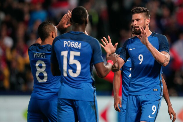 France's Olivier Giroud, right, celebrates after scoring with teammate Paul Pogba, center, and Dimitri Payet, during the friendly soccer match between France and Scotland at the Saint Symphorien Stadium in Metz, eastern France, Saturday, June 4, 2016. The French squad is in preparation for the EURO 2016 soccer championships which will start on June 10, 2016. (AP Photo/Thibault Camus)