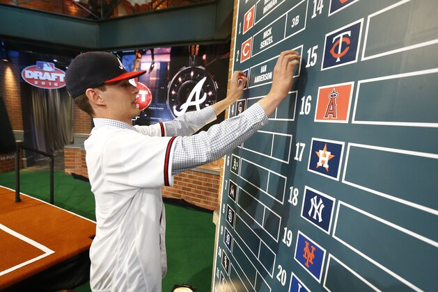 Ian Anderson, a pitcher from Shenendehowa High School in Clifton Park, N.Y., puts his name on the board after being drafted No. 3 by the Atlanta Braves in the first round of the Major League Baseball draft, Thursday, June 9, 2016, in Secaucus, N.J. (AP Photo/Julio Cortez)