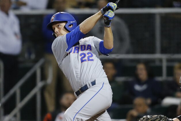 CORAL GABLES, FL - FEBRUARY 26: JJ Schwarz #22 of the Florida Gators hits a solo home run against the Miami Hurricanes in the sixth inning on February 26, 2016 at Alex Rodriguez Park at Mark Light Field in Coral Gables, Florida. Florida defeated Miami 5-0. (Photo by Joel Auerbach/Getty Images)