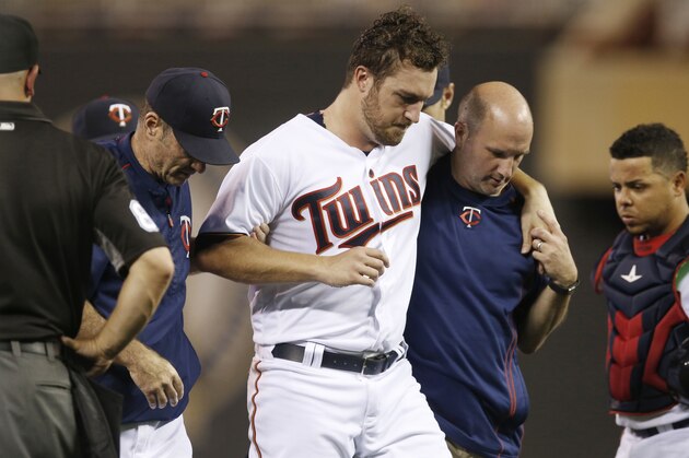Minnesota Twins pitcher Phil Hughes is helped off the field by trainer Tony Leo, right, and manager Paul Molitor, left, after he was hit in the knee with a line drive by Miami Marlins' J.T. Realmuto during the ninth inning of a baseball game Thursday, June 9, 2016, in Minneapolis. The Marlins won 10-3. (AP Photo/Jim Mone)