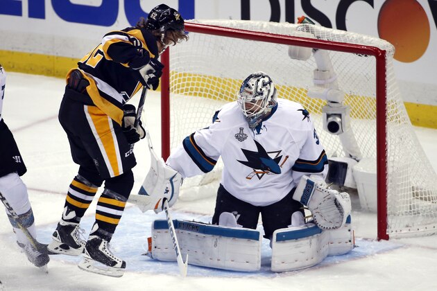 Pittsburgh Penguins' Carl Hagelin, left, scores a goal against San Jose Sharks goalie Martin Jones (31) during the first period in Game 5 of the NHL hockey Stanley Cup Finals on Thursday, June 9, 2016, in Pittsburgh. (AP Photo/Gene J. Puskar)