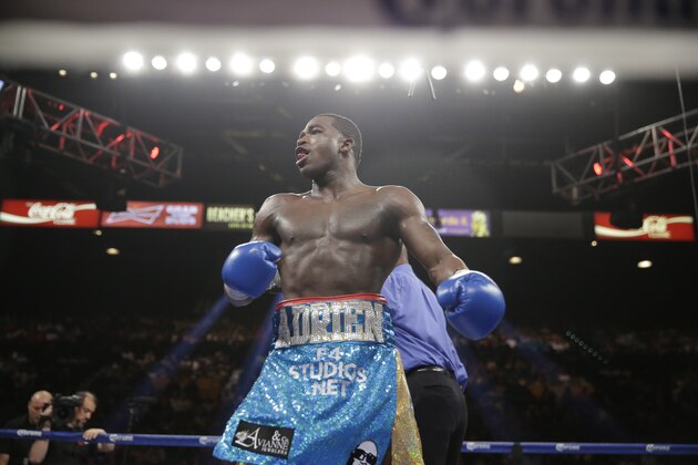 Adrien Broner celebrates his unanimous decision victory over Carlos Molina in their WBA super lightweight title boxing fight Saturday, May 3, 2014, in Las Vegas. (AP Photo/Eric Jamison)