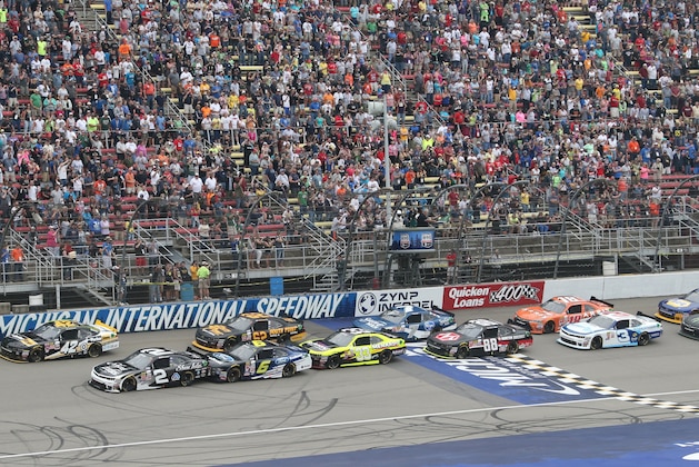 The cars in the NASCAR Xfinity series auto race cross the start line on a restart at Michigan International Speedway, Saturday, June 13, 2015, in Brooklyn, Mich. (AP Photo/Bob Brodbeck)