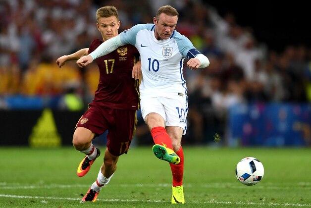 MARSEILLE, FRANCE - JUNE 11: Wayne Rooney of England and Oleg Shatov of Russia compete for the ball during the UEFA EURO 2016 Group B match between England and Russia at Stade Velodrome on June 11, 2016 in Marseille, France.  (Photo by Laurence Griffiths/Getty Images)